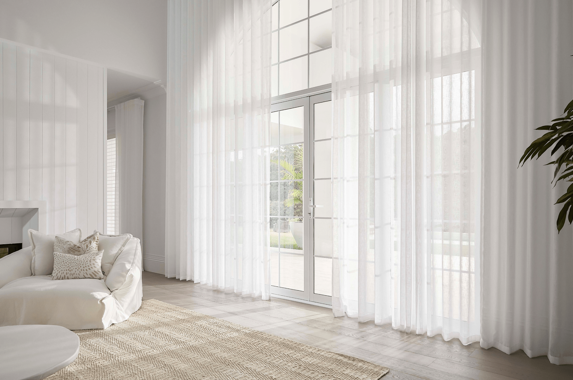 Modern light-filled living room with made to measure sheer curtains in Adelaide, featuring soft flowing fabrics.