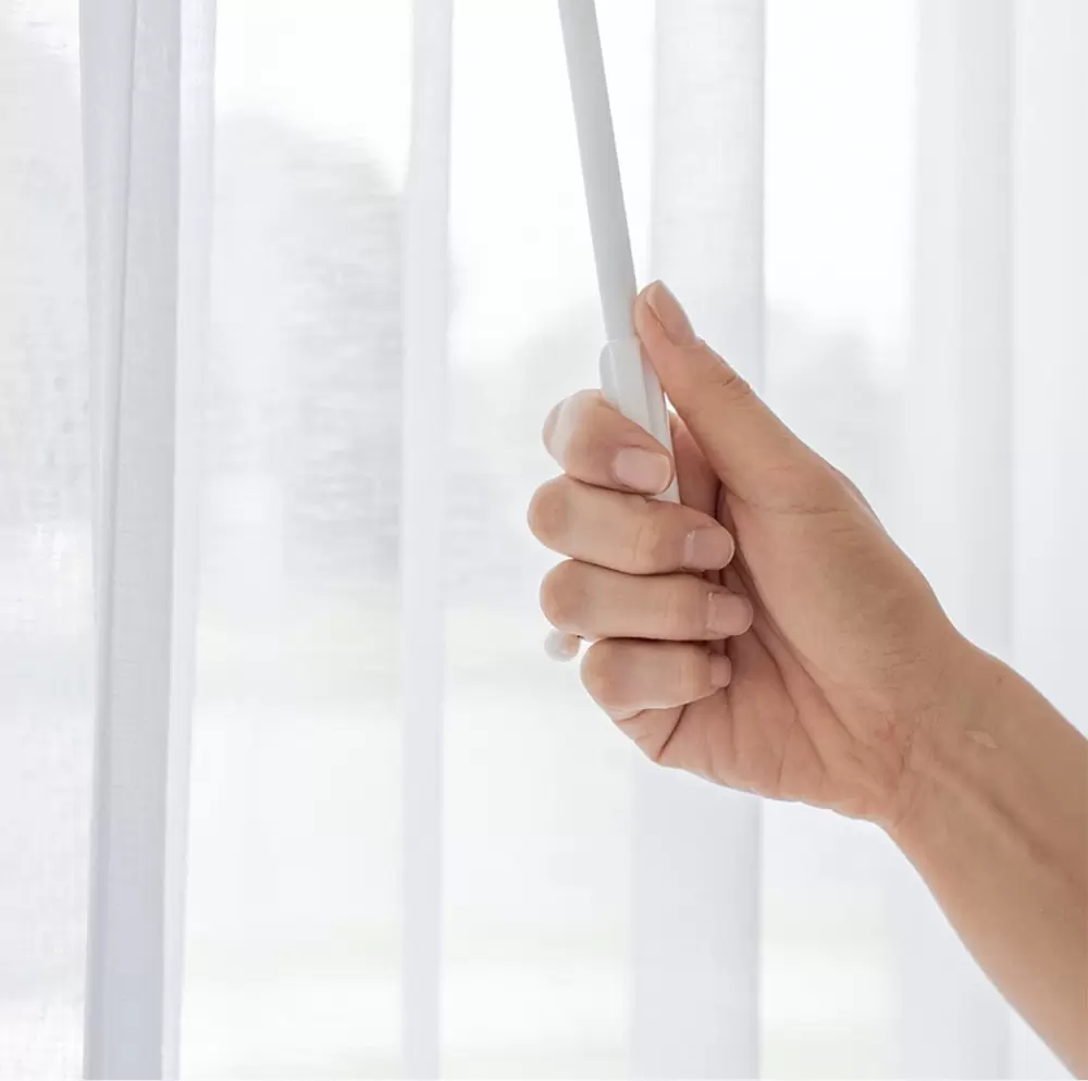 Easy Operation with Curtain Pull Wands - Adelaide’s Trusted Supplier Curtain pull wand in use with elegant curtains, showcasing options for sheer, blockout, and outdoor shades